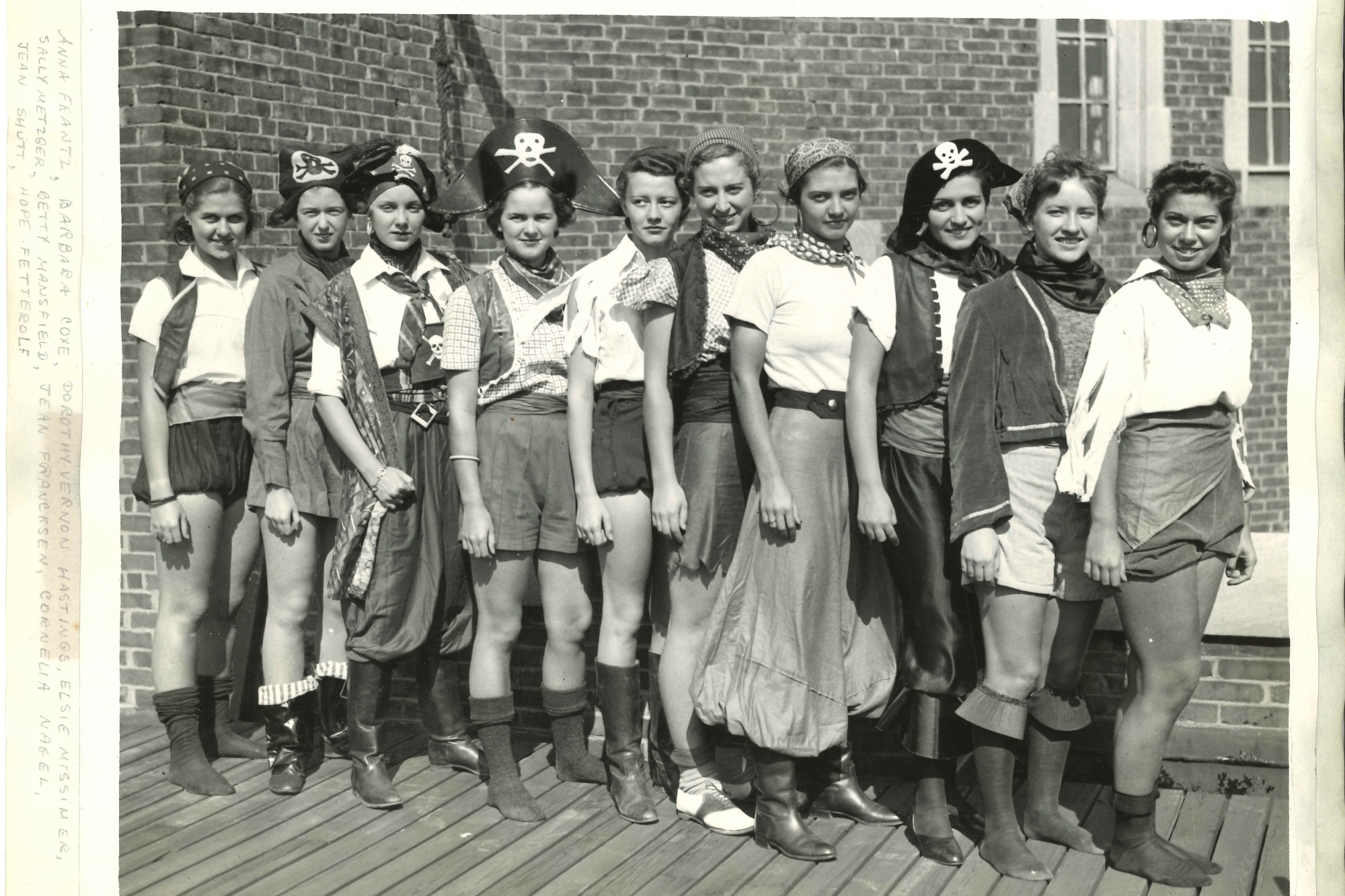 A group of students dressed up as pirates standing in a line, turned to face the camera slightly.