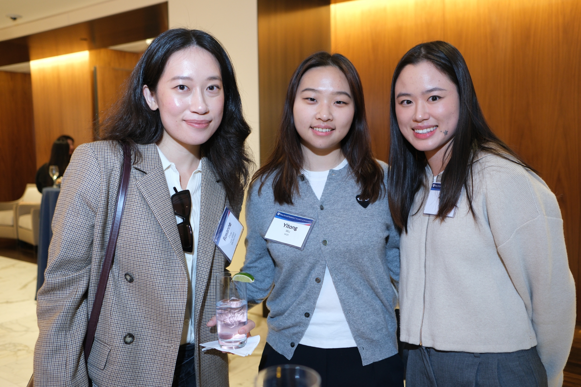 Three people standing and posing for the camera.