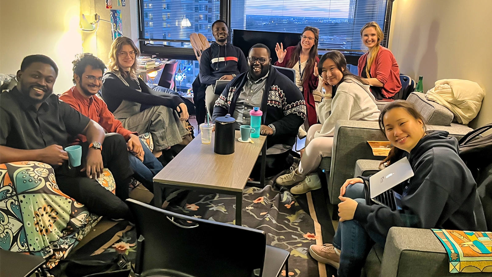 Graduate students sitting in living room. 